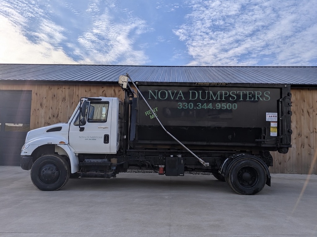 Nova Dumpsters branded roll-off truck parked at the home base